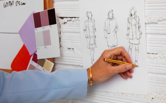 a female fashion designer working on clothing in a studio