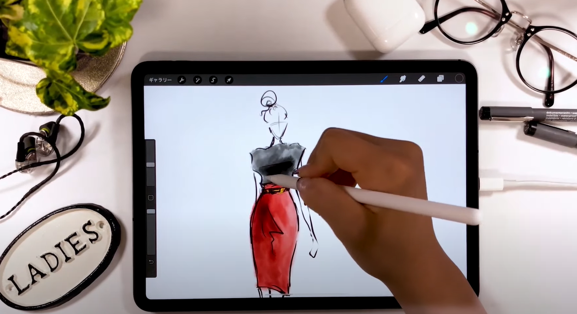 Fashion designer utilizing Procreate for design creation