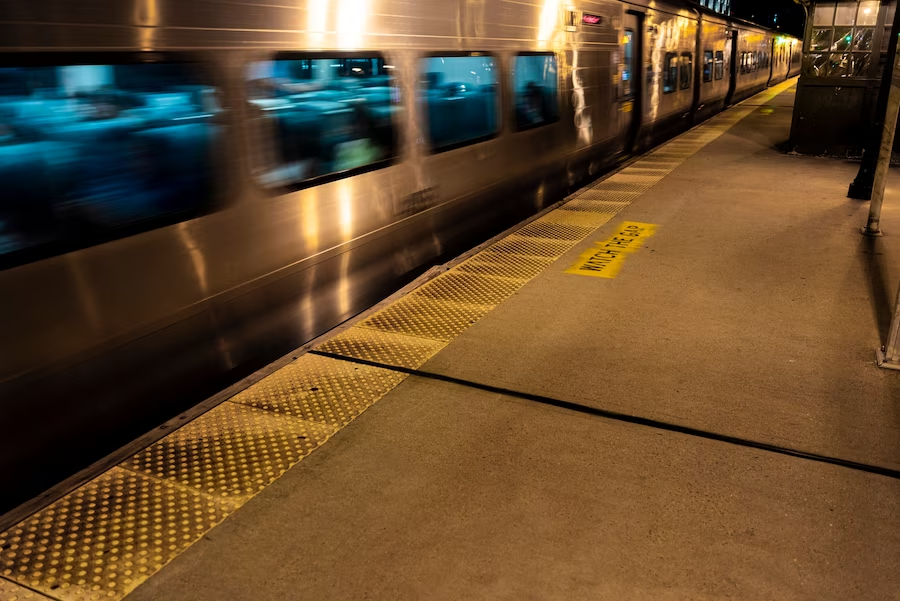 A subway train in motion at a subway station