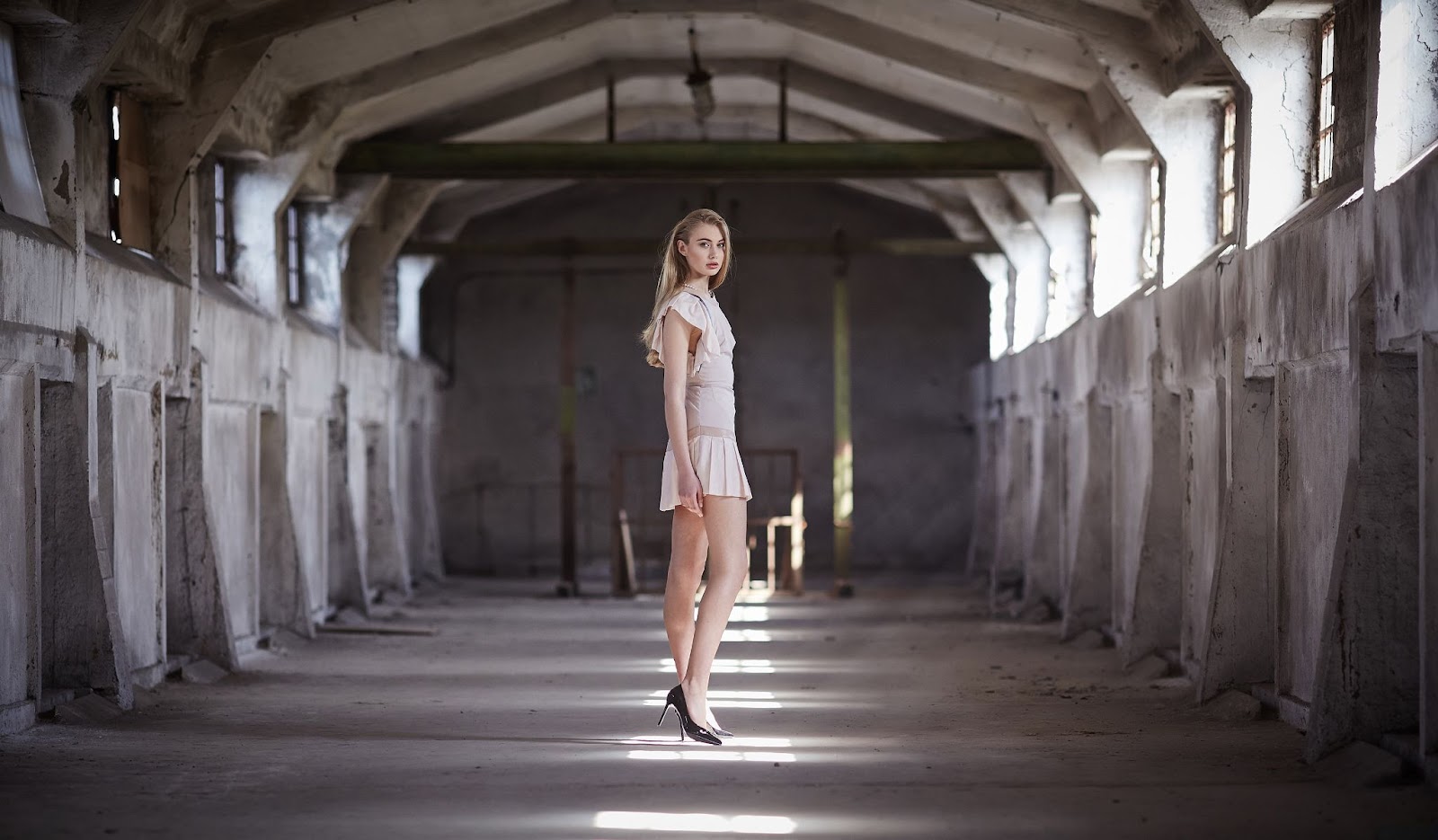 Blond female in posing in a big hall